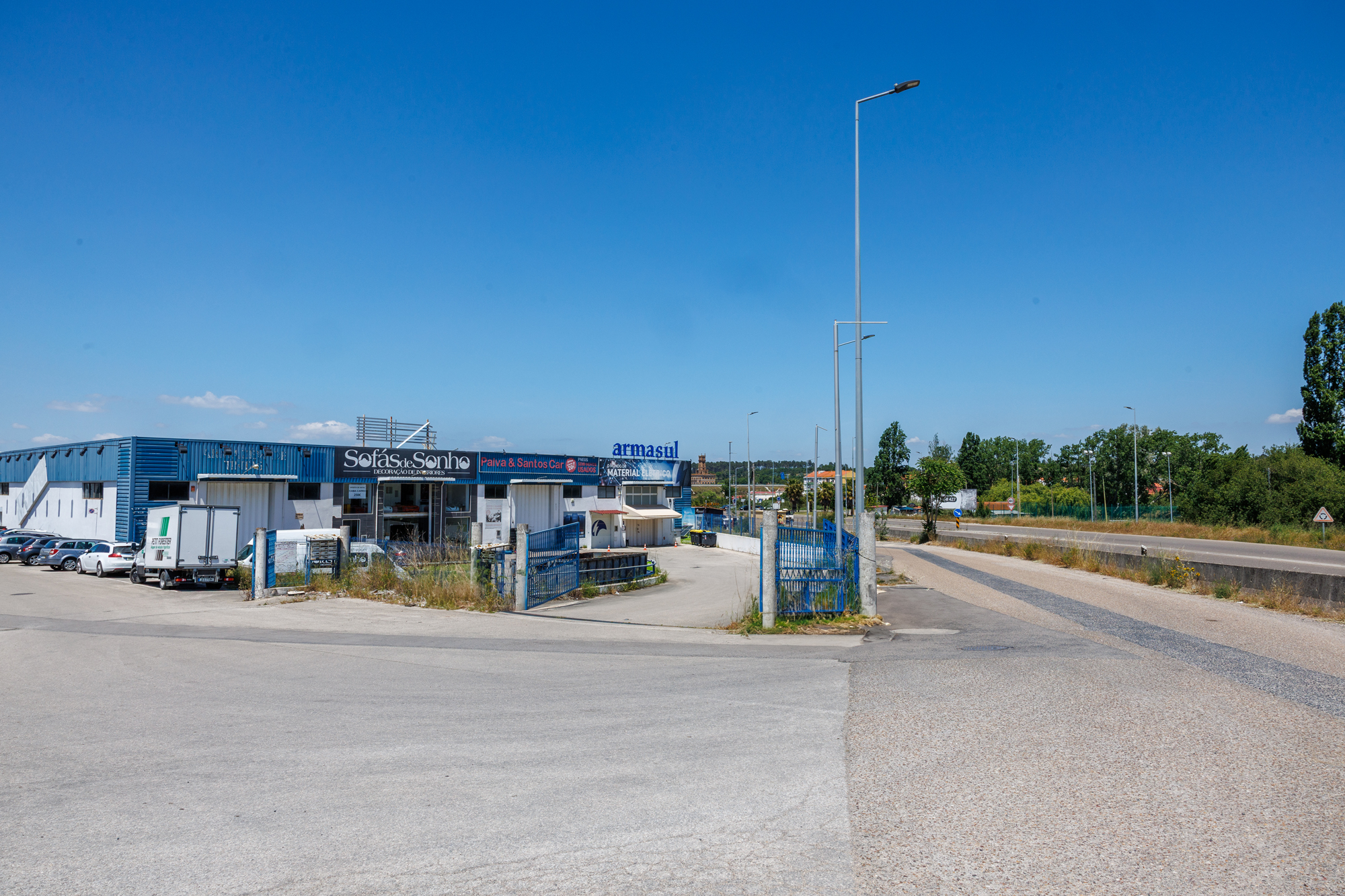 Fotografia da Zona Industrial de Coina com os alguns dos armazéns e a estrada que fica ao lado