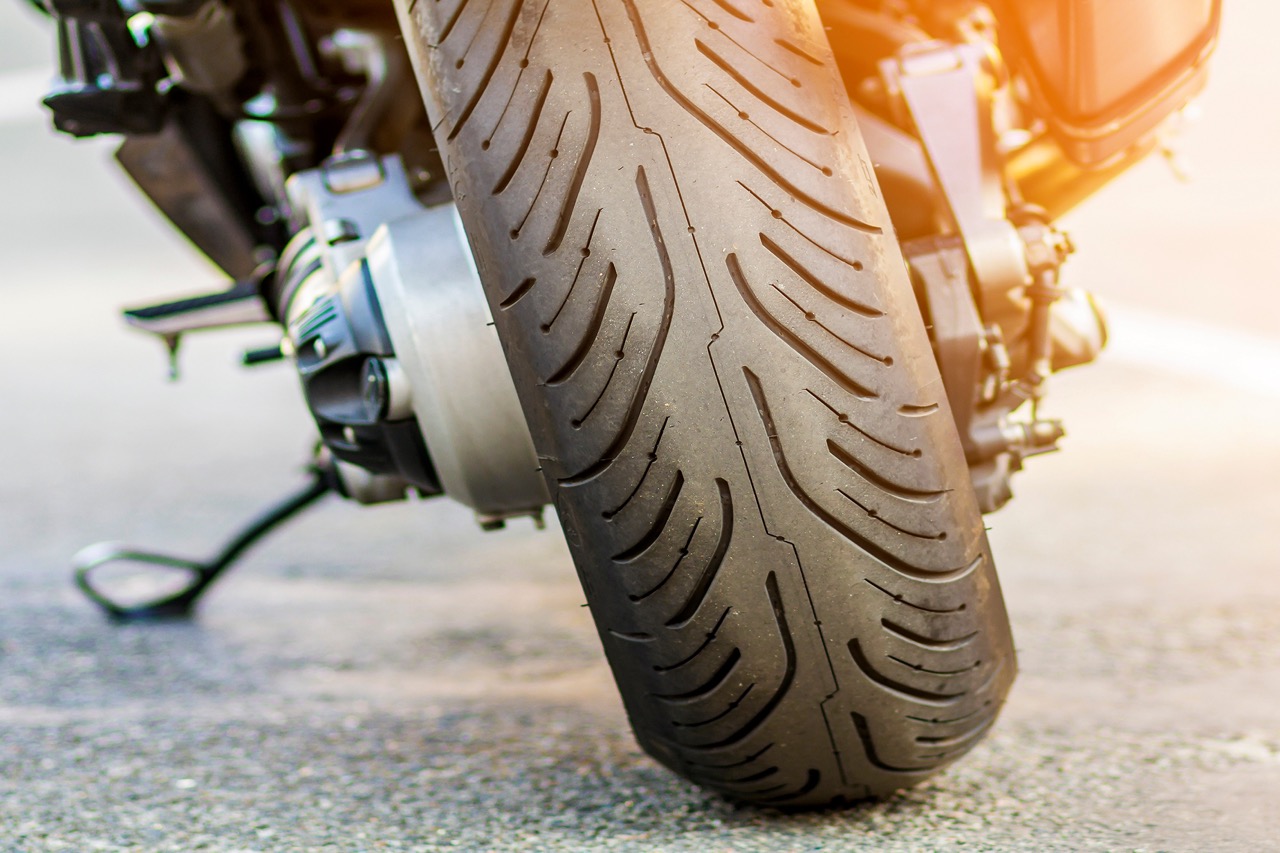 Roda traseira de uma mota desportiva na estrada. Moto estacionada numa rua.